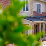 Exterior of Pinewood Place townhomes with front porches along the row