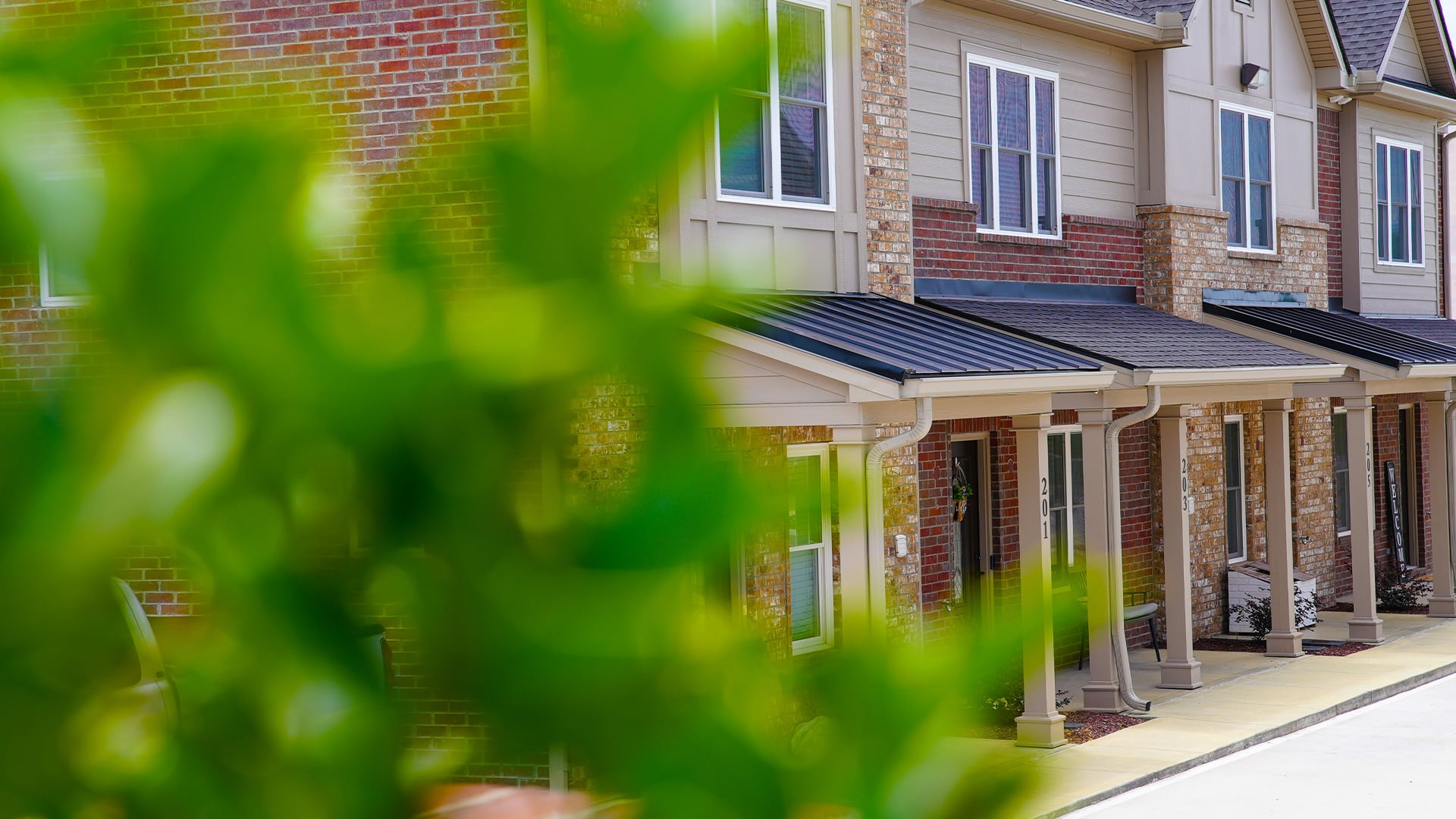 Exterior of Pinewood Place townhomes, front porches along the row